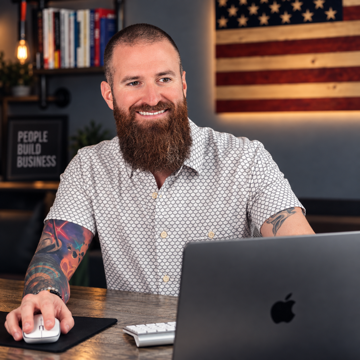 A shop owner smiling at his desk