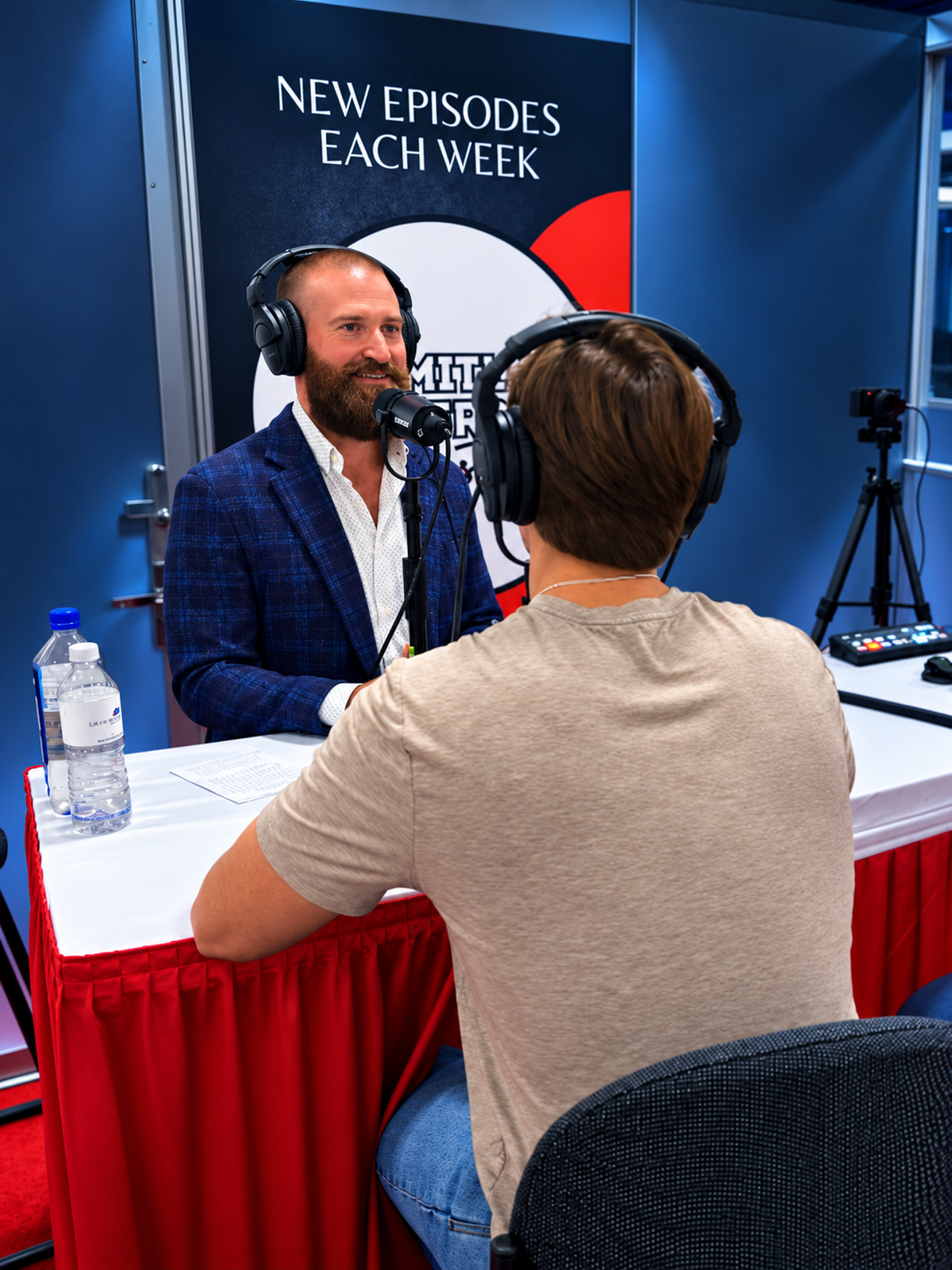 Two men recording an interview at the Limitless Leadership podcast booth
